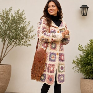 May include: A long-sleeved crochet cardigan featuring a multi-colored granny square pattern in shades of cream, purple, pink, and green, with wooden buttons down the front. A brown leather crossbody bag with a circular top and long fringe hangs.