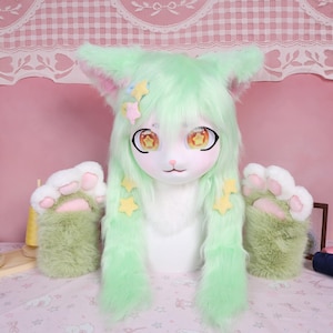 May include: A cat-themed cosplay mask with matching paw-shaped gloves. The mask features large, expressive eyes, a white face, and mint green hair with star accents. The gloves are green with white and pink paw pads.