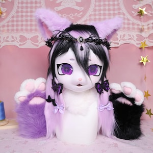 May include: A white and purple fursuit head with large purple eyes and black and white hair. The ears and paws are purple. The fursuit has a black crown and black bows. The paws are black and white.
