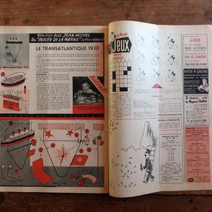May include: Open vintage magazine pages with illustrations and text. The left page features a diagram of a ship and text in French, including "LE TRANSATLANTIQUE 1930." The right page has crossword puzzles and other graphics.