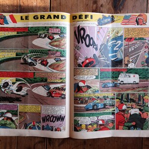 May include: Open vintage comic book pages featuring a race car theme. The comic book has colorful illustrations of race cars on a track, with text bubbles and action words. The title "LE GRAND D&Eacute;FI" is visible.