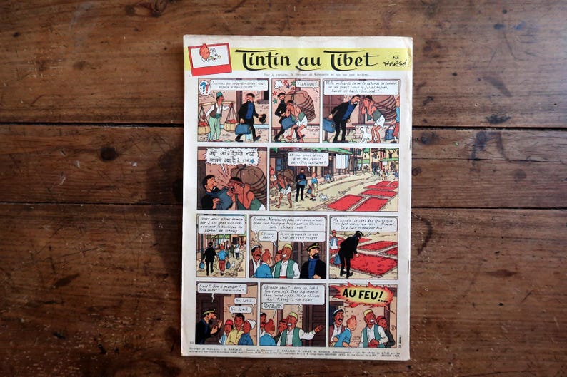 May include: A vintage comic book page titled Tintin au Tibet by Herg&eacute;, featuring multiple colorful panels with illustrations of characters in various settings, including street scenes and dialogue bubbles with French text throughout the page.