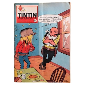 May include: A vintage comic book cover featuring a scene from Tintin. The cover displays a cartoon illustration of two characters in a room. One character is covered in a yellow substance, while the other is looking out a window. Text includes "TINTIN" and "LE JOURNAL DES JEUNES".