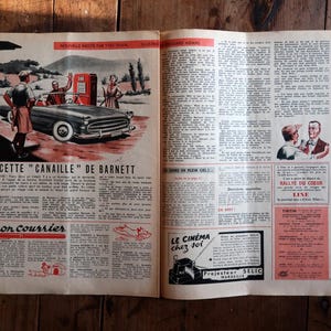 May include: Open vintage magazine spread with a car advertisement. The ad features a classic car at a gas station with people. Text includes "CETTE CANAILLE DE BARNETT" and "Mon courrier". The page has a reddish-brown hue.