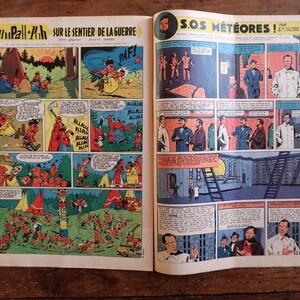 May include: Open comic book pages featuring colorful panels with illustrations and text. The left page has the title "Oumpah-Pah sur le sentier de la guerre" and comic strip panels. The right page has the title "S.O.S. M&eacute;t&eacute;ores!" with comic strip panels.