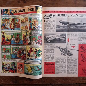 May include: Open vintage comic book pages with colorful illustrations. One page features a comic strip titled "LA CAVALE D'OR". The other page has aviation-themed articles with images of airplanes and helicopters. The pages are on a wooden surface.