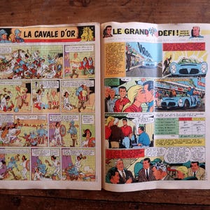 May include: A vintage comic book spread featuring two distinct stories. The left page is titled LA CAVALE D'OR and depicts historical scenes with knights. The right page is titled LE GRAND D&Eacute;FI and shows modern race car scenes and characters.