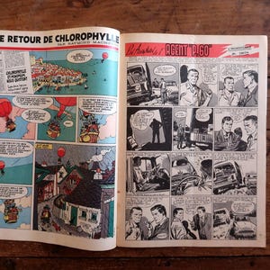 May include: Open vintage comic book pages featuring colorful panels. One page displays a comic strip titled "LE RETOUR DE CHLOROPHYLLE" with illustrations of hot air balloons. The other page shows "AGENT P.60" panels.