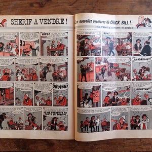 May include: Open comic book pages with a vintage Western theme. The title "SHERIF A VENDRE!" is visible, along with comic panels featuring cowboys, saloons, and speech bubbles. The comic is in black, white, and red.