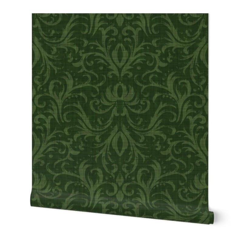 May include: A roll of dark green wallpaper with a repeating damask pattern. The design features swirling floral and leaf motifs in varying shades of green, creating a textured, vintage look. The wallpaper is partially unrolled, revealing the pattern's repeat.