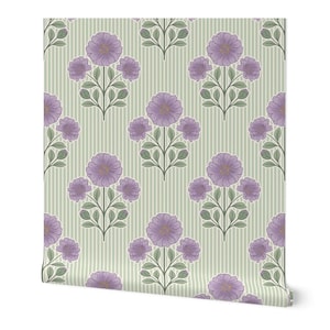 May include: A roll of wallpaper featuring a repeating pattern of purple flowers with green leaves and stems arranged on a light sage green background with thin, vertical white stripes. The floral design is symmetrical and evenly spaced.