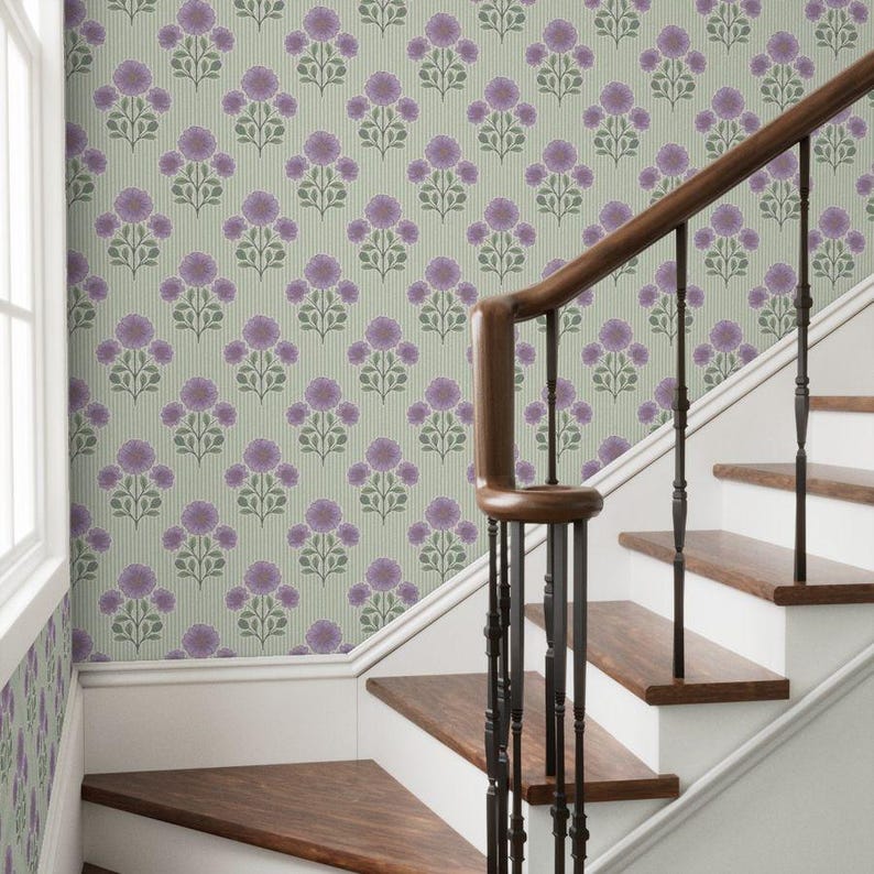 May include: Wallpaper featuring a repeating pattern of purple floral clusters with green stems and leaves on a light green background with thin vertical stripes, installed on a wall next to a wooden staircase with a dark brown handrail.