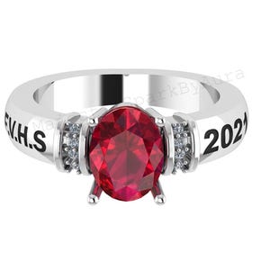 May include: A silver ring with a large, oval-cut, red gemstone as the centerpiece. The ring features the text "FVH.S" and "2021" on the band, with small accent stones on each side of the main stone. The ring is a graduation or class ring.