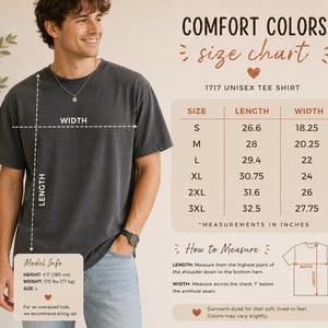 May include: A charcoal gray short-sleeve t-shirt with a size chart displaying measurements in inches for sizes S through 3XL. The chart includes length and width dimensions, model information, and instructions on how to measure the garment.