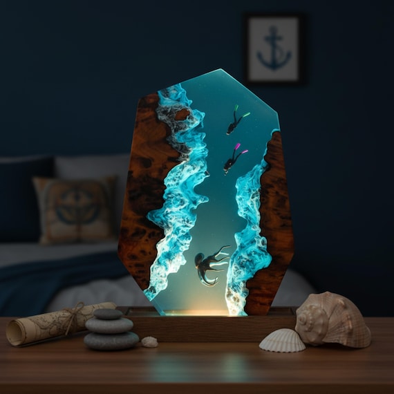 A hand-poured epoxy resin lamp with a fully realized underwater diorama inside — octopus, scuba divers, ocean floor and all — that glows from within like a window into another world.