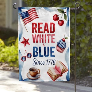 May include: A white garden flag with patriotic imagery, including an American flag, cherries, a cupcake, and a coffee cup. The flag reads "Read White & Blue Since 1776" in red and blue lettering. The flag is designed for outdoor use.