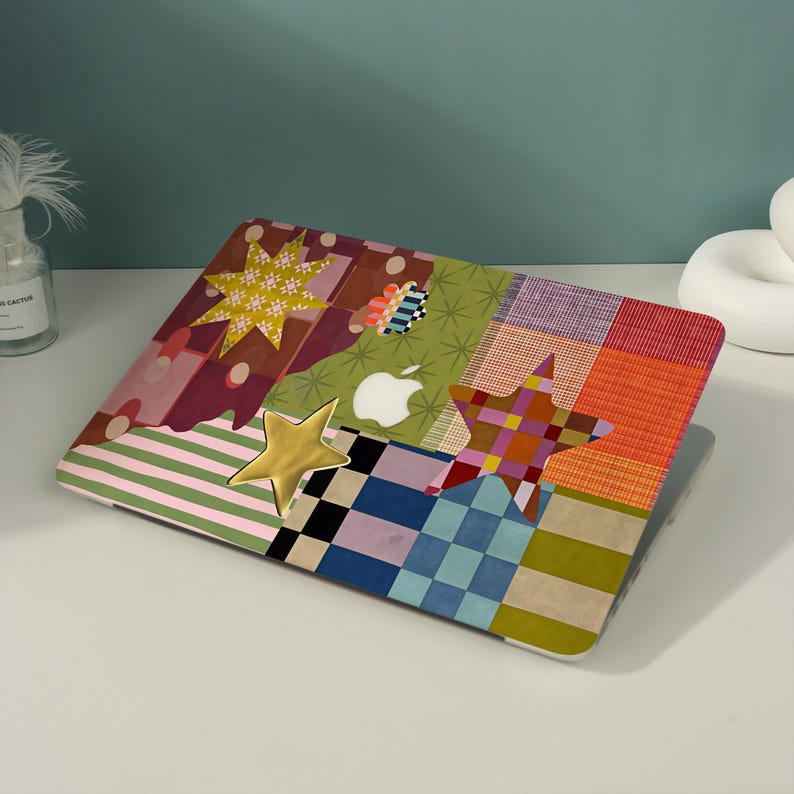 May include: A laptop skin featuring a patchwork design of various patterns including stripes, checks, and solid colors in shades of green, blue, orange, and red. The design includes a gold star, a patterned star, and a white Apple logo cutout.