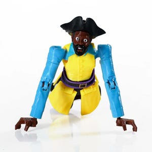 May include: A plastic action figure of a pirate with a black tricorn hat, a yellow coat, and bright blue sleeves. The figure has a dark brown beard, wide white eyes, and brown hands. The arms are extended outward, and the figure lacks legs.