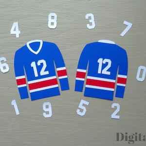 May include: Two blue hockey jerseys with white and red stripes, each displaying the number 12. White numbers 0-9 are scattered around the jerseys. The words "Digital File" are in the bottom right corner.