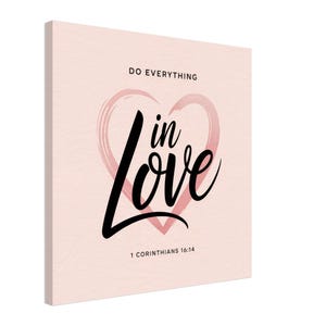 May include: A light pink canvas print with the words "DO EVERYTHING" at the top. Below, the words "in Love" are written in a stylish black script, inside a pink heart. The text "1 CORINTHIANS 16:14" is at the bottom.