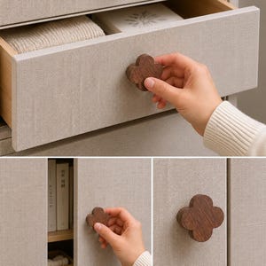 May include: A set of dark brown wooden cabinet knobs featuring a four-leaf clover shape. These knobs are mounted on light beige fabric-covered drawers and cabinet doors, providing a contrast between the natural wood grain and the textured surface.