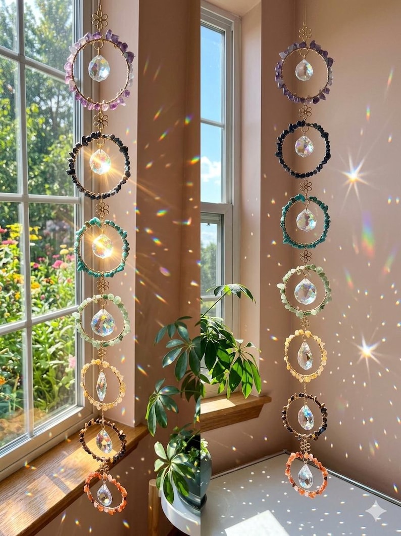 May include: A set of hanging crystal suncatchers with colorful gemstone rings. Each ring features a central crystal pendant and is connected by a delicate gold chain. The gemstones include amethyst, black tourmaline, turquoise, and citrine, creating a rainbow effect.