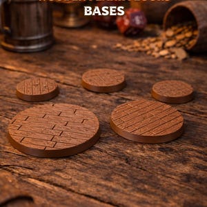 May include: Circular brown wooden bases with a plank floor design, ideal for tabletop gaming. The image shows several bases of different sizes, with the text "DUNGEONS & DRAGONS WOODEN PLANK FLOORS BASES" at the top.