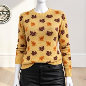 May include: Mustard yellow sweater featuring a pattern of brown and orange maple leaves. The sweater has a crew neck and long sleeves. The logo on the upper left says "COZYLOOP FOR MEN AND WOMEN."