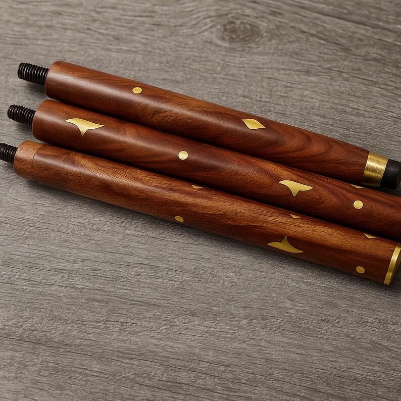 May include: Three wooden furniture legs with a rich brown finish. Each leg features gold-colored decorative accents in the shape of dots and stylized leaves. The legs have threaded ends for easy attachment. The legs are angled slightly, suggesting they are for a table or chair.