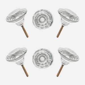 May include: A collection of six clear glass cabinet knobs. Each knob features a faceted, diamond-like design and a threaded bronze-colored screw for installation. The knobs are arranged against a plain white background.