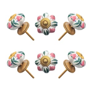 May include: Six floral cabinet knobs. The knobs are white with pink and green floral designs, gold accents, and brass-colored hardware. The knobs are arranged on a white background.