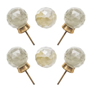 May include: A set of five clear, faceted glass cabinet knobs with brass-colored bases and threaded rods. The knobs are spherical and have a geometric design. Two additional knobs are also visible.