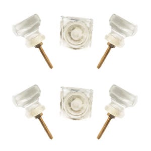 May include: Six clear glass cabinet knobs with a ribbed design and brass screws. The knobs are square and round, with a vintage aesthetic. The hardware is ideal for updating furniture or adding a touch of elegance to any room.