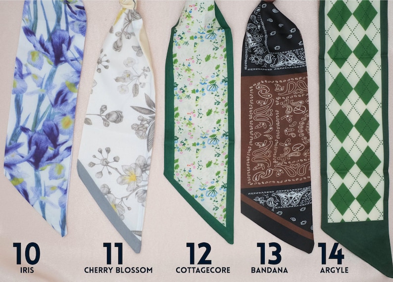 Five colorful fabric scarves with different designs. One is blue with a iris flower pattern, another is beige with cherry blossoms, a third is green and white in floral cottagecore style, the fourth has is in classic bandana pattern with brown and black colors. The last has green argyle pattern. Each scarf has a number and a descriptive word.