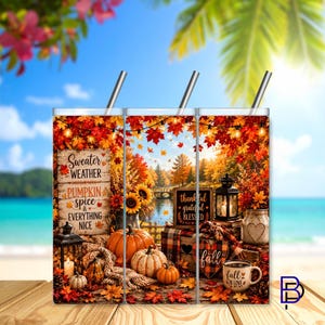 May include: A cylindrical tumbler with a metal straw featuring an autumn-themed design with orange pumpkins, sunflowers, lanterns, and fall foliage. The text reads Sweater Weather, Pumpkin Spice & Everything Nice, Thankful Grateful Blessed, and Fall.
