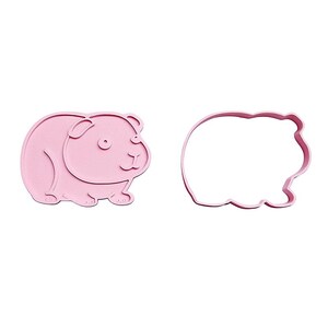 May include: Two pink cookie cutters shaped like a guinea pig. One is a solid pink form of the animal, and the other is an outline of the same shape. The cutters are on a white background.