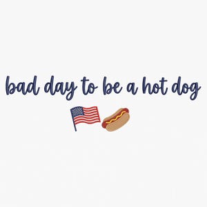 May include: A graphic design featuring the dark blue text "bad day to be a hot dog" in a cursive script font. Below the text, there is a small illustration of an American flag on a pole next to a hot dog in a bun with a line of yellow mustard.
