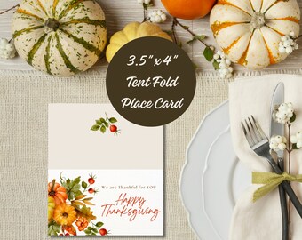 May include: A 3.5" x 4" tent fold place card with a fall theme. The card features a watercolor illustration of pumpkins, leaves, and berries. The text "We are Thankful for YOU Happy Thanksgiving" is printed in red on the card.