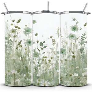 May include: Three stainless steel tumblers with a white background and a design of green and white pressed flowers.