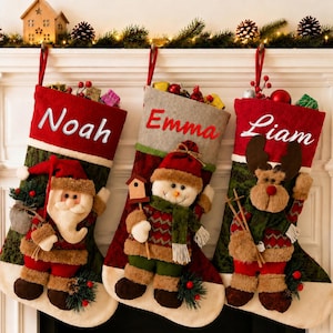 May include: Three Christmas stockings featuring embroidered names Noah, Emma, and Liam. Each stocking displays a plush character: a Santa Claus, a snowman, and a reindeer. The stockings are red and green with white cuffs and festive accents.