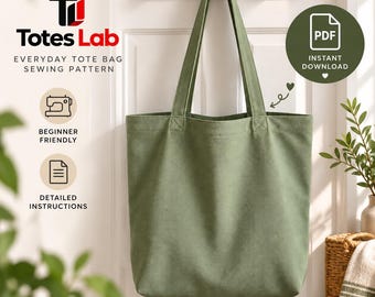 May include: A sage green canvas tote bag with two long shoulder straps, hanging from a wooden hook. The image includes text: Totes Lab, Everyday Tote Bag Sewing Pattern, Beginner Friendly, Detailed Instructions, and PDF Instant Download.