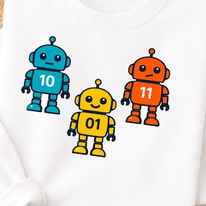 May include: White sweatshirt featuring three colorful robot graphics. The robots are blue, yellow, and orange, each with a different number: 10, 01, and 11. The design is simple and cartoonish, suitable for children's apparel.