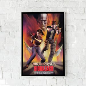 May include: Framed poster featuring the video game Gun Survivor 2 Biohazard Code: Veronica. The artwork depicts two characters holding guns, set against a fiery background with a large face. The game's title is prominently displayed.
