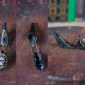 Detail shots of individual gothic claw rings showing construction.