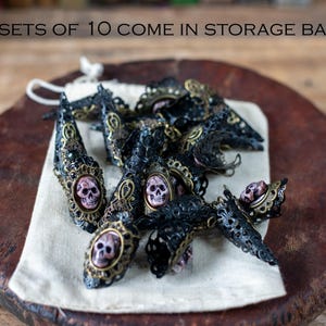 Set of 10 pirate nail claws displayed inside cotton storage bag.