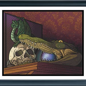 May include: A framed cross-stitch artwork featuring a green dragon perched atop a human skull, positioned next to a large green alligator head with an open mouth containing a glowing purple orb, all set against a dark red damask patterned background.