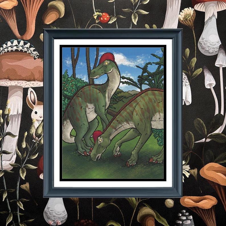 May include: A framed illustration featuring two green dinosaurs with red crests standing in a grassy landscape with trees and a blue sky. The artwork is enclosed in a black frame with a white mat, set against a dark background with mushrooms.