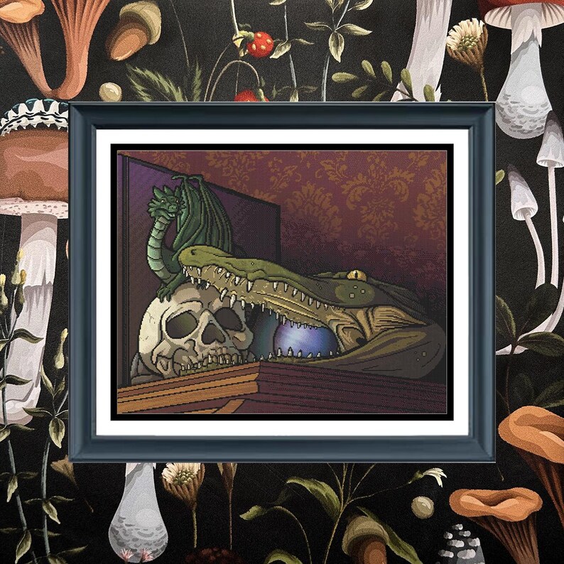 May include: A framed art print featuring a green dragon perched atop a human skull, positioned next to a large crocodile head with an open jaw containing a glowing blue orb. The scene is set against a dark red damask patterned wall background.