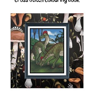 May include: A Dinosaurs Cross Stitch Colouring Book featuring a framed illustration of two green dinosaurs with red crests in a landscape. The text reads 387 x 500 stitches, 55 x 71 cm @ 14ct, 22 x 28 in @ 14ct, and 109 Colours.