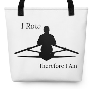 May include: A white tote bag with black handles featuring a black silhouette of a person rowing a boat. The text "I Row" is printed above the silhouette, and the text "Therefore I Am" is printed below the silhouette in a black serif font.